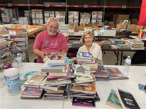 Sorting and repairing books at American Furniture Warehouse